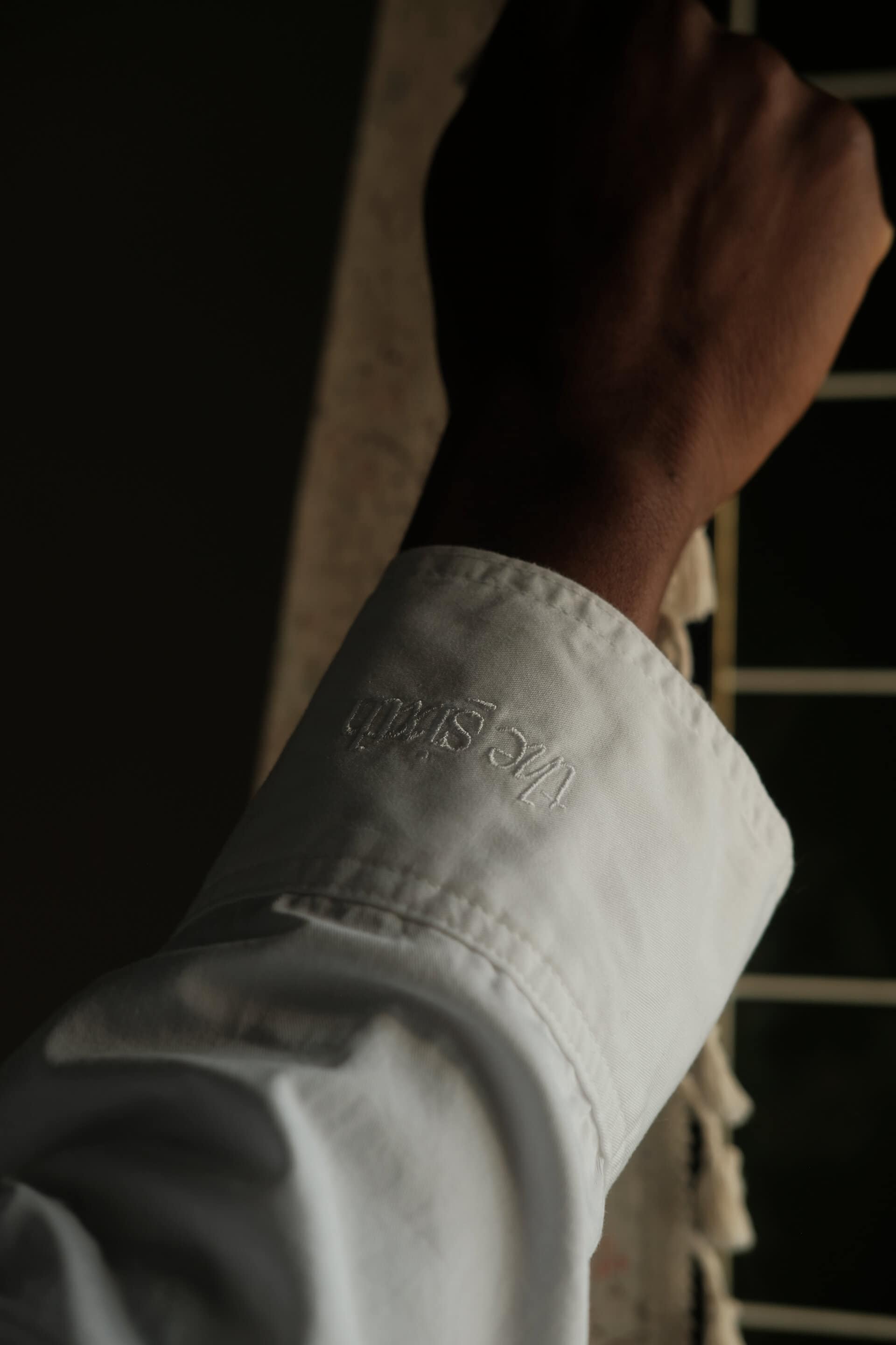 Close up shot of the seasons shirt cuff, showing The Sixth logomark on the sleeve. 